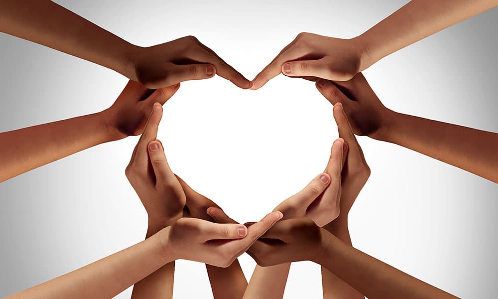 Ten cupped hands formign the outline of a heart shape